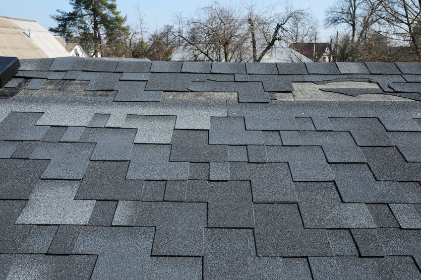 storm damage on roof loose shingles